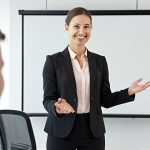 **

Prompt: *Confident individual giving a presentation. Focus on strong, positive body language (upright posture, friendly smile). Background: a modern office or conference setting.*

**